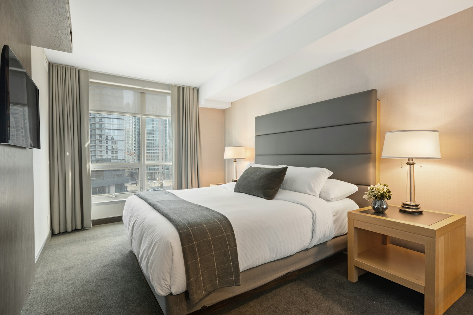 A made hotel bed in a bright room — atmosphere, not this lodge